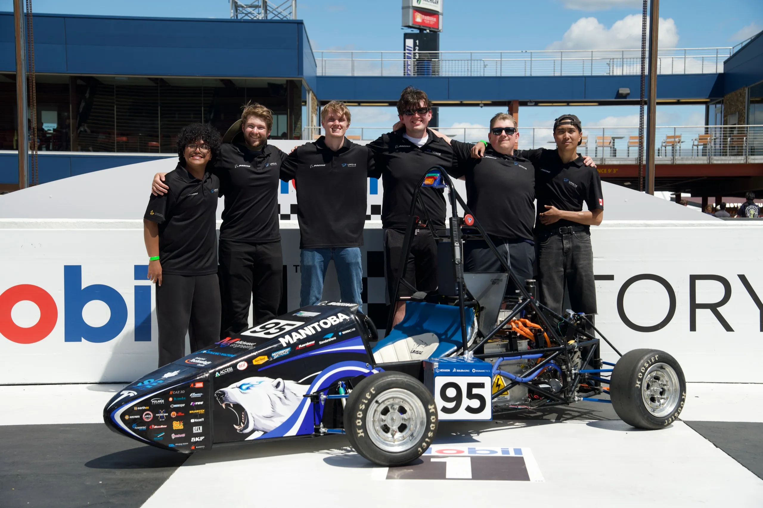 Team group shot with the car
