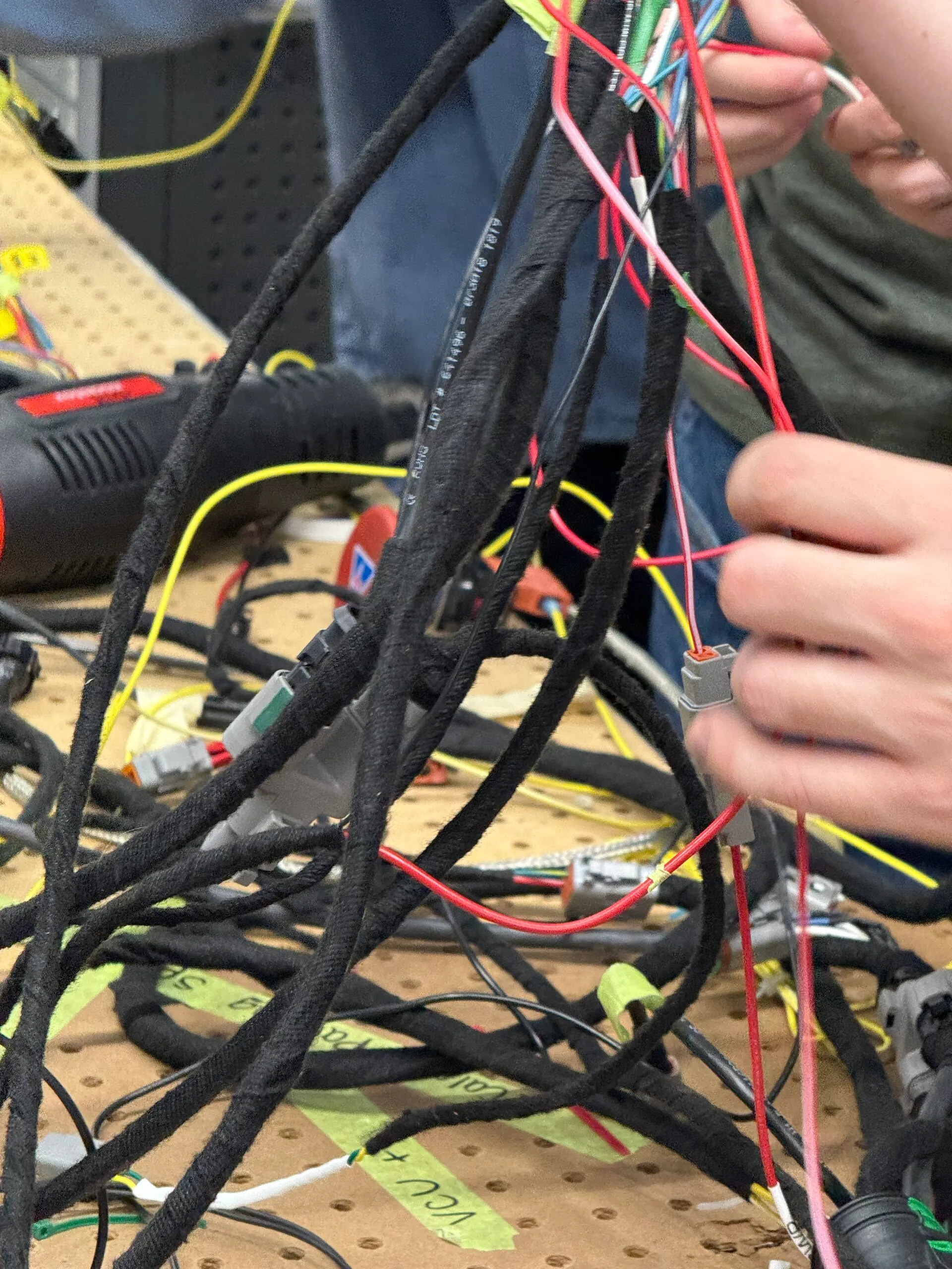 Harness build. Every node the topology added is a branch someone has to route, label, and be able to unplug in a paddock